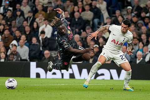 Jeremy Doku, left, is fouled by Pedro Porro